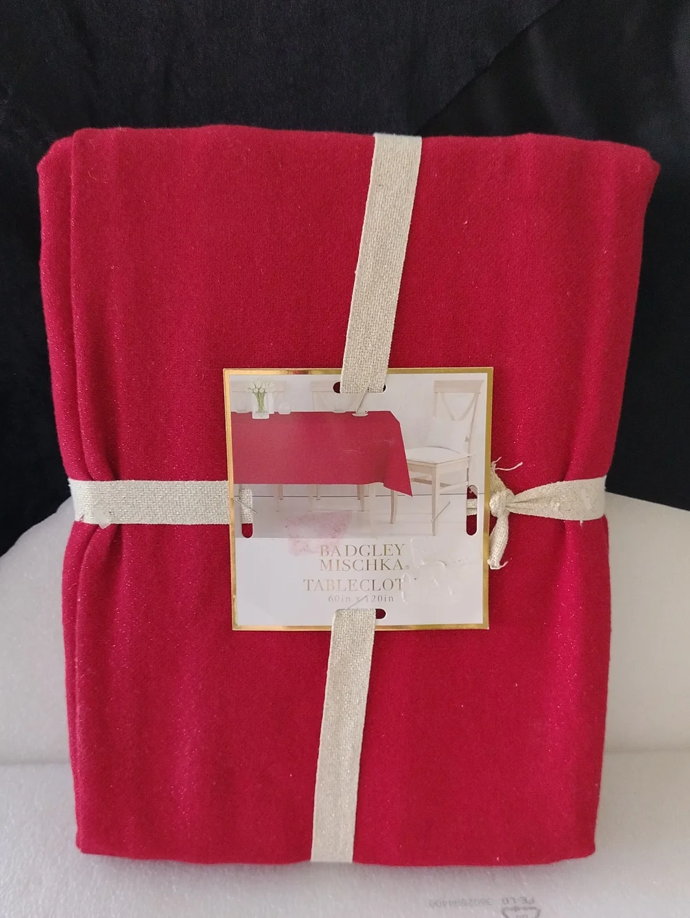 Badgley Mischka Red Rectangle tablecloth measuring 60 by 120 inches.